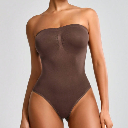 Brown strapless bodysuit worn by a model on a gray background