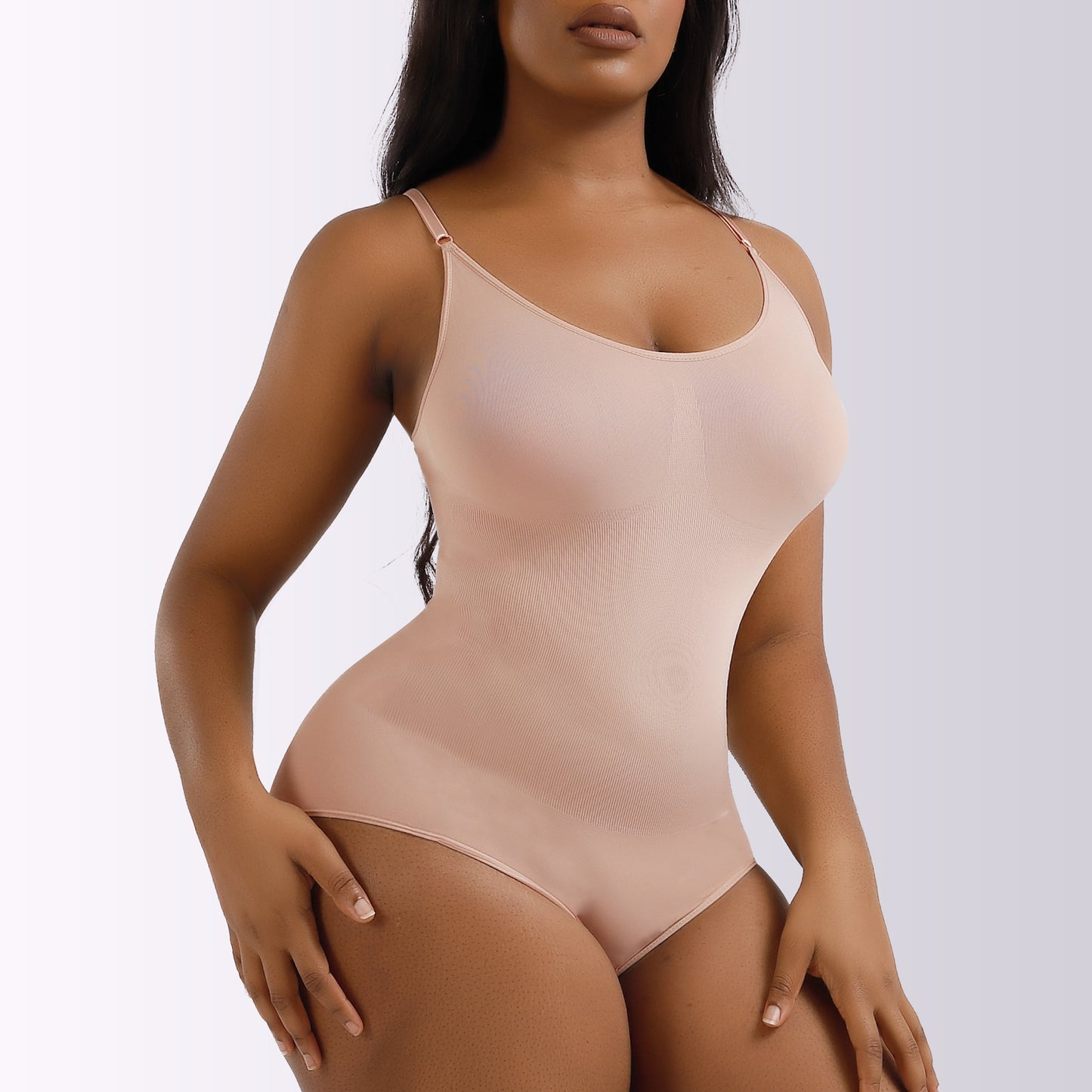 Beige bodysuit worn by a model on a white background