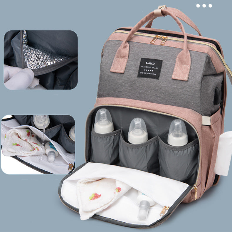 Open baby bag with bottles and wipes on a light blue background