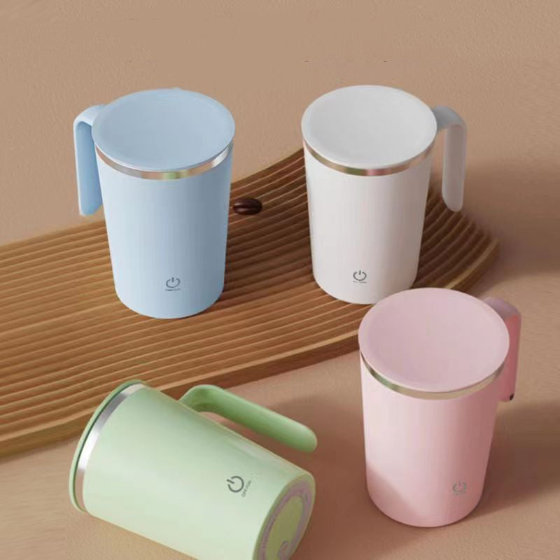 Four colorful mugs (blue, white, pink, green) on a wooden surface with a beige background.