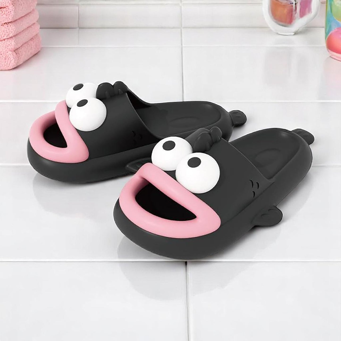 A pair of blue EVA slippers designed to resemble a cartoon character, with large eyes and a happy expression.