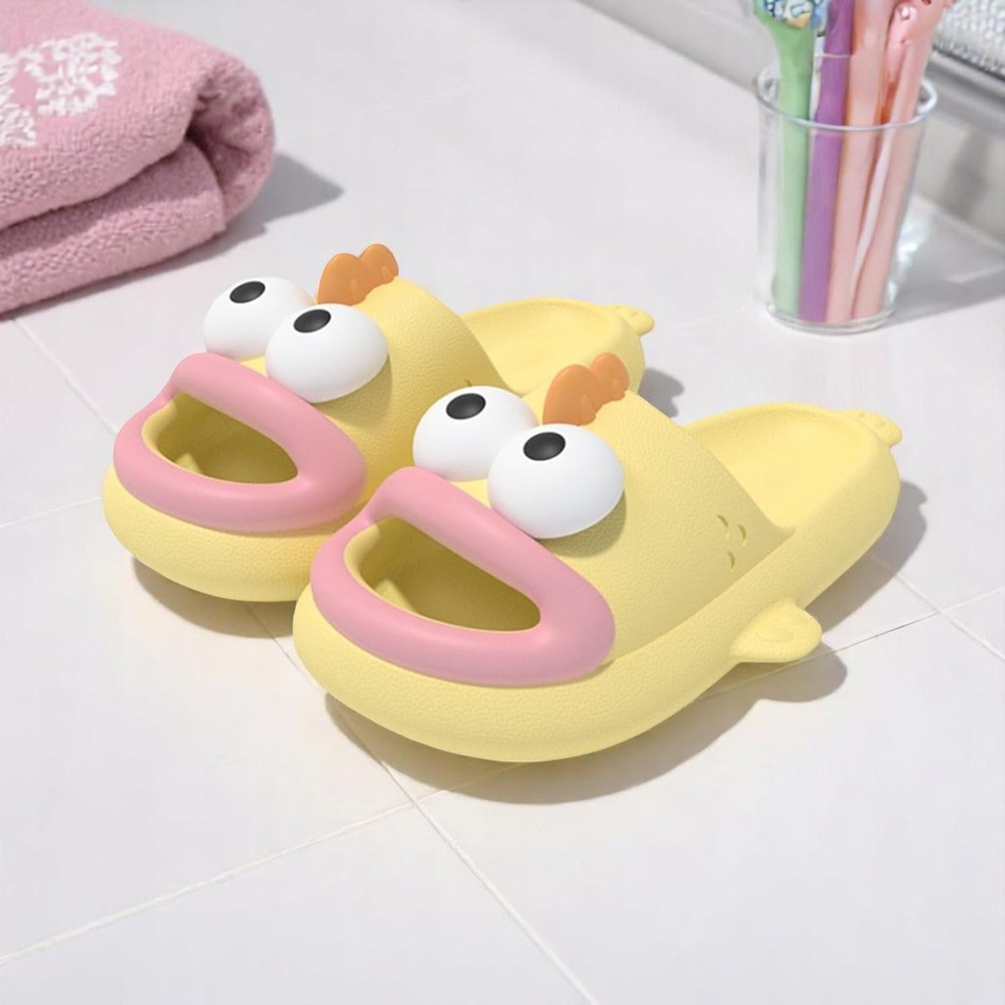 A pair of blue EVA slippers designed to resemble a cartoon character, with large eyes and a happy expression.