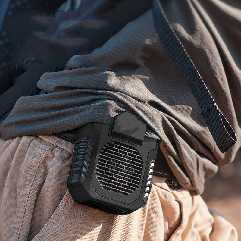Black tactical fan attached to a person's belt with beige pants.