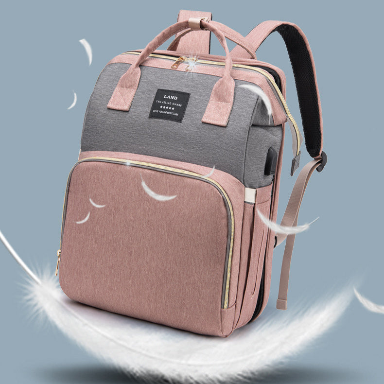 Two-tone pink and gray backpack on a light blue background