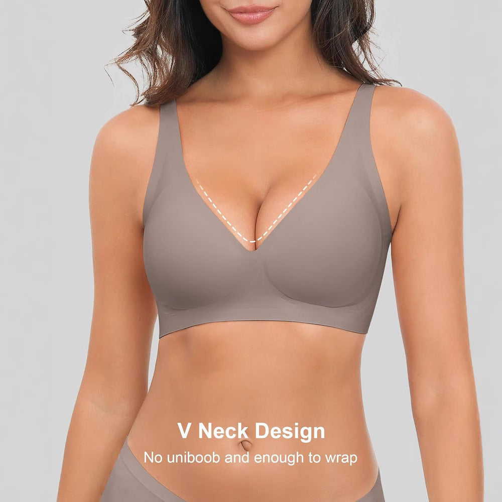 Woman wearing a beige V-neck bralette on a gray background