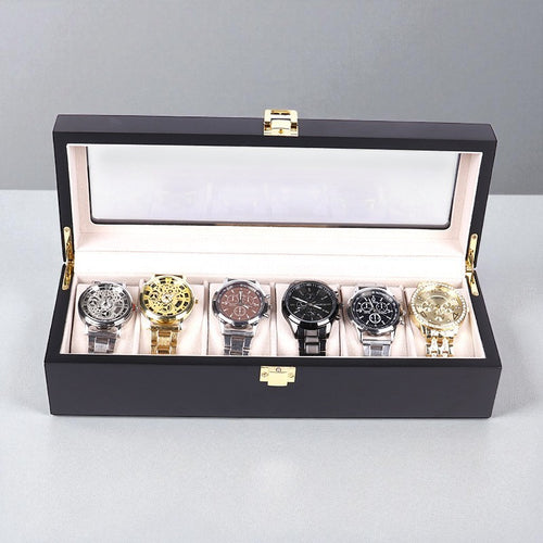 Luxury black watch box with six watches displayed on a light gray background