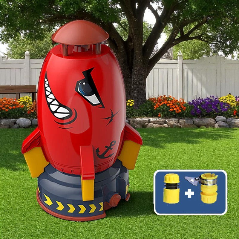 Red and blue robot-like inflatable toy on grass with garden and fence in the background