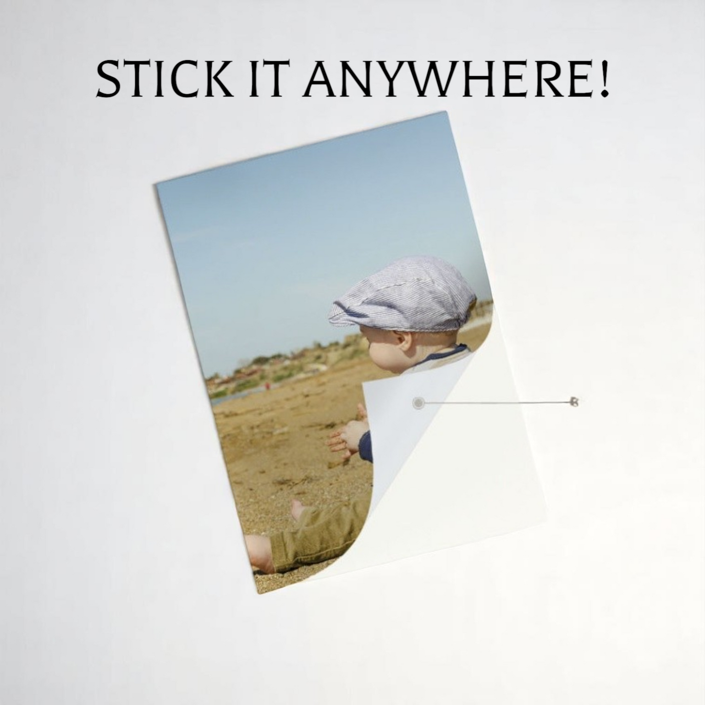Poster with a child in a field and text 'STICK IT ANYWHERE!' on a light gray background