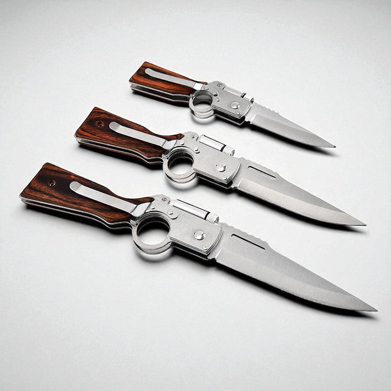 Three folding knives with wooden handles on a light gray background