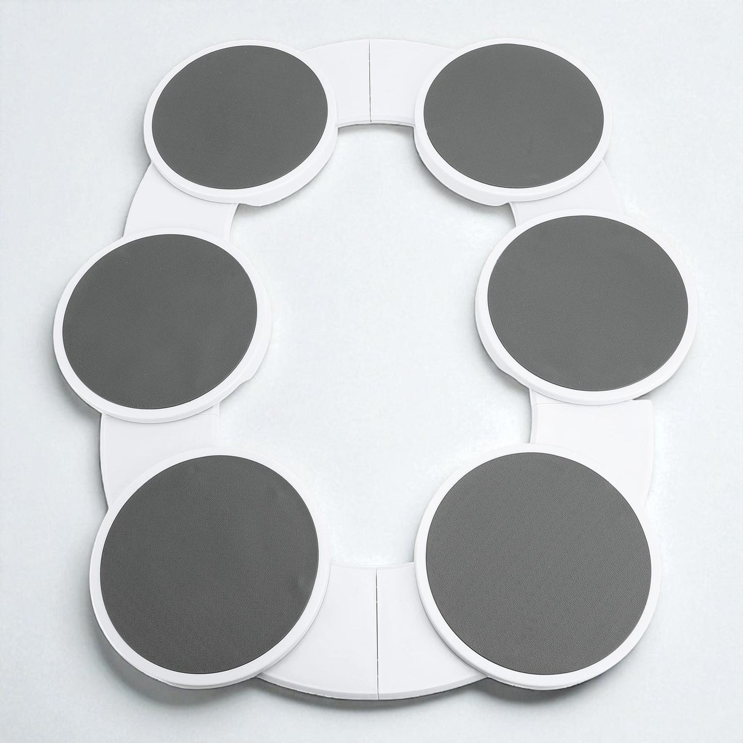 Circular object with gray and white sections on a light gray background