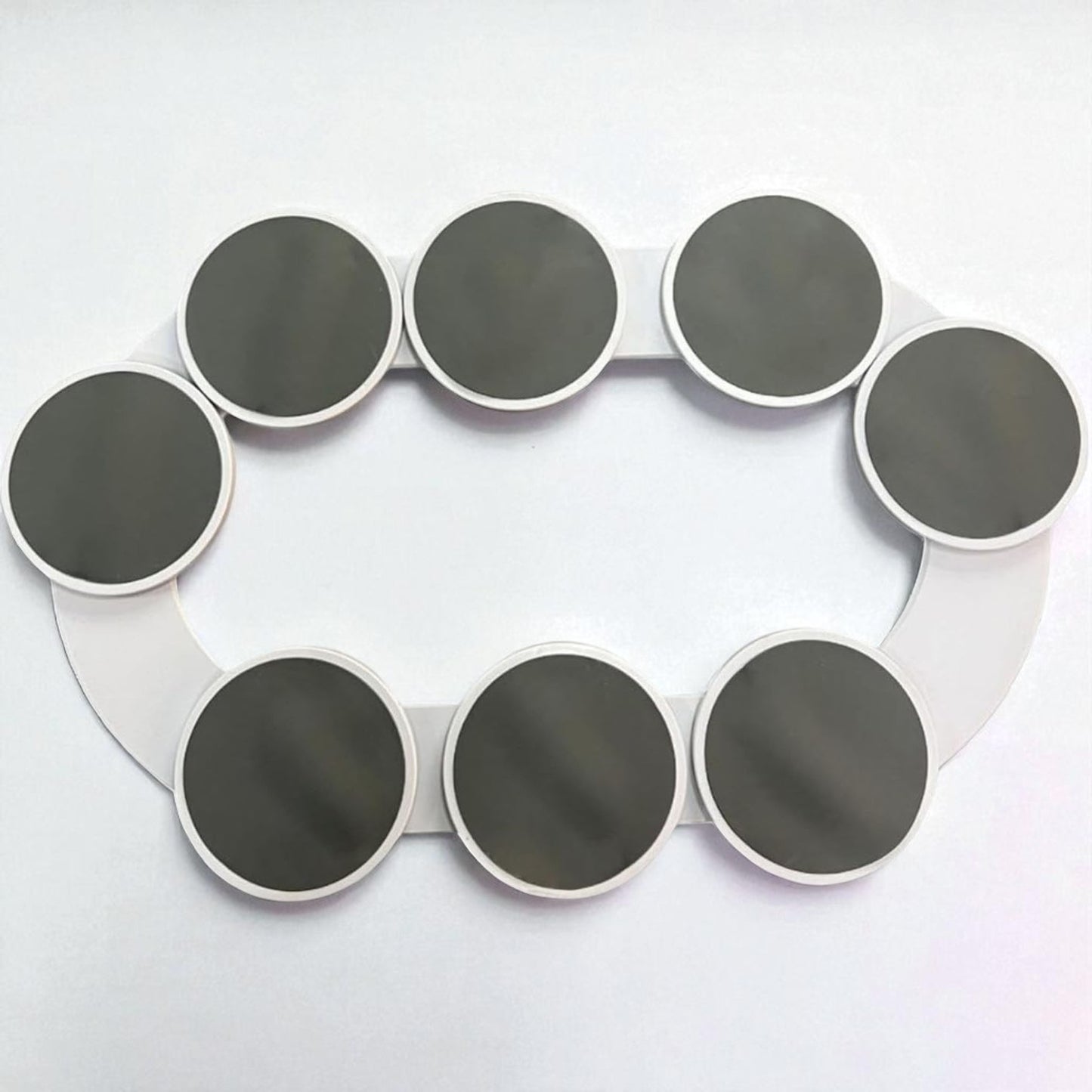 Circular device with multiple black circular components on a white background