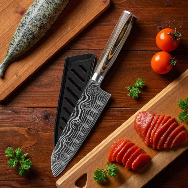 Chef's knife with a decorative blade on a wooden surface with sliced tomatoes and herbs.
