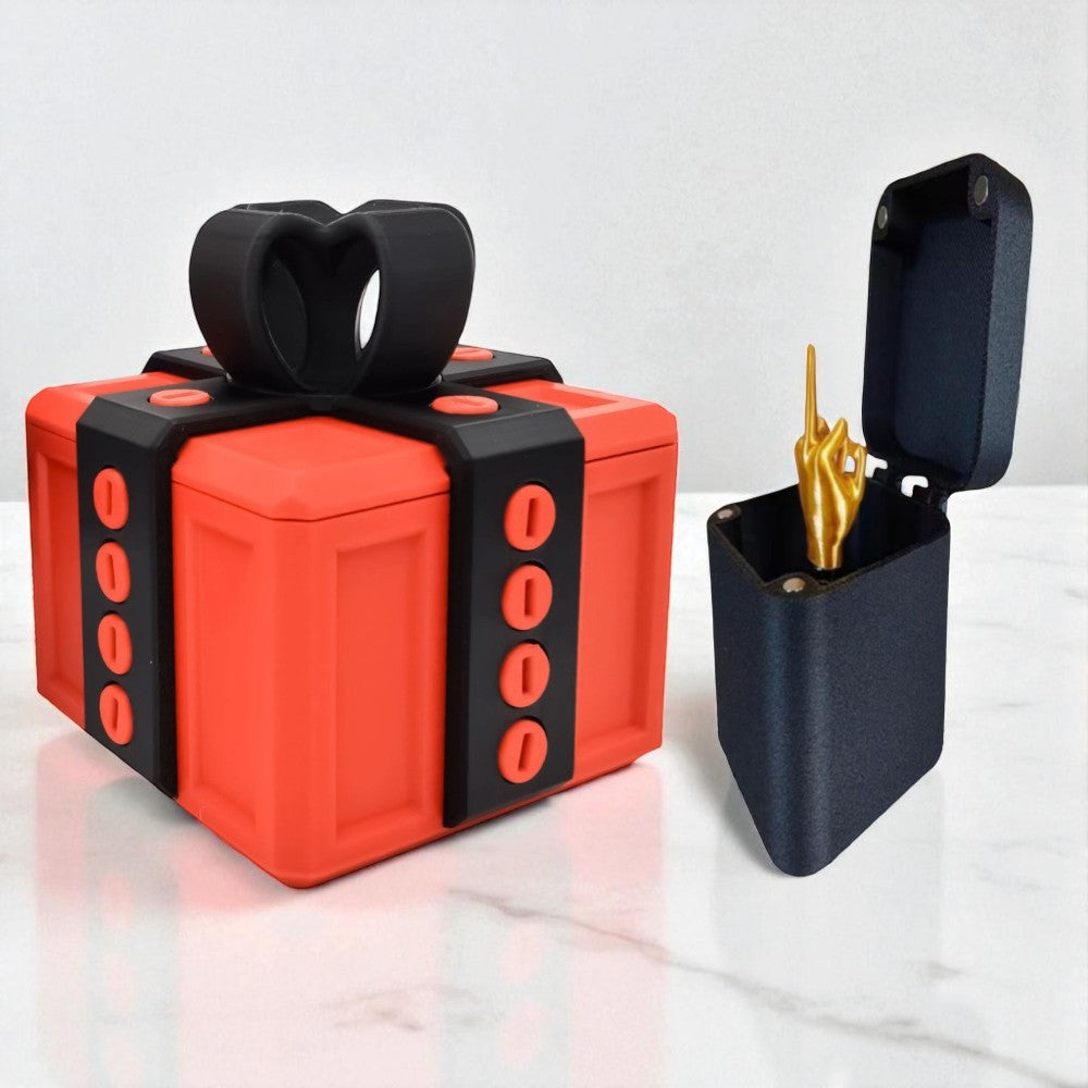 Red gift-shaped box with black band and open black box revealing a gold object on a white background