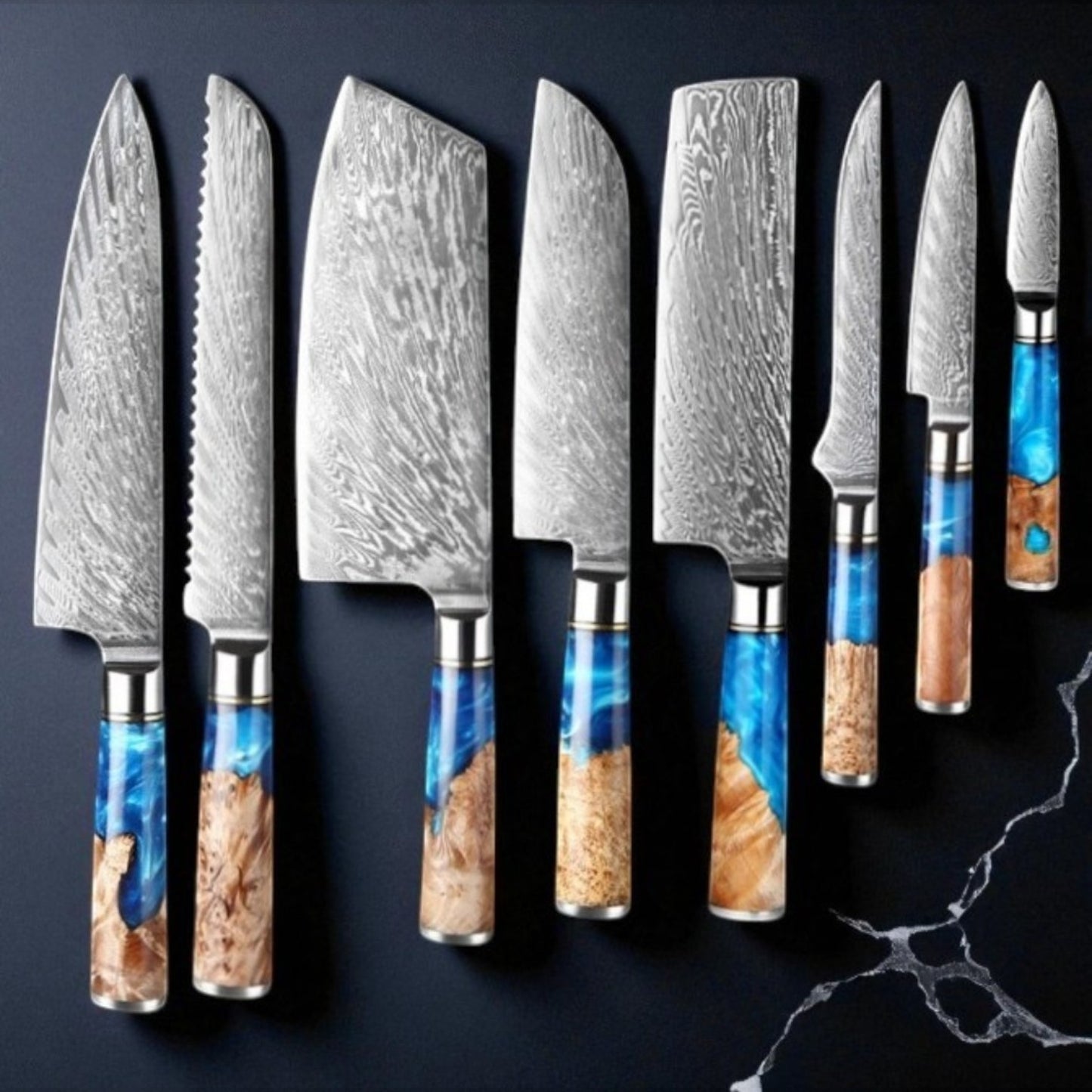 Set of Damascus steel kitchen knives with various handle designs on a dark background