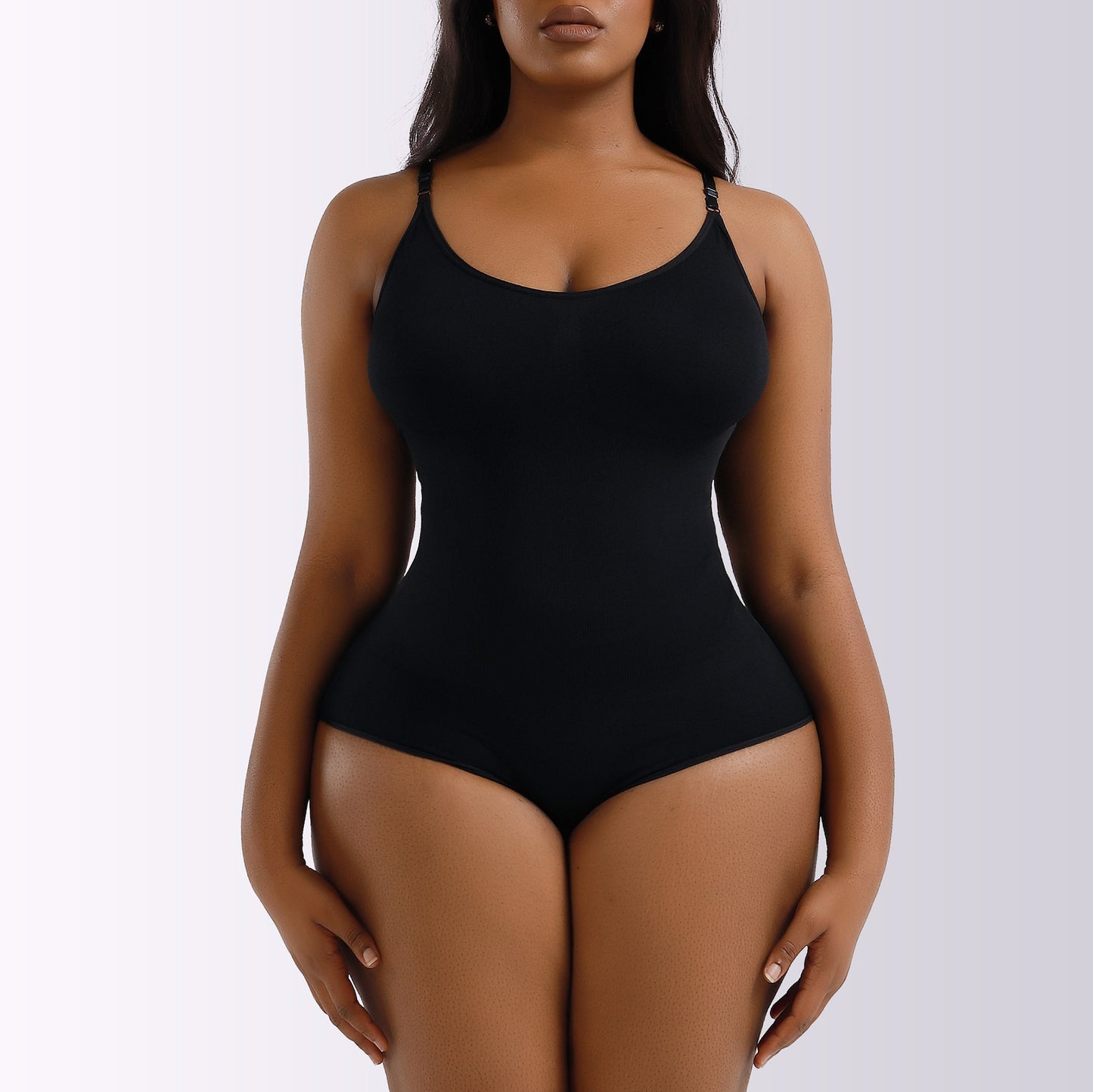 Black bodysuit worn by a model on a white background