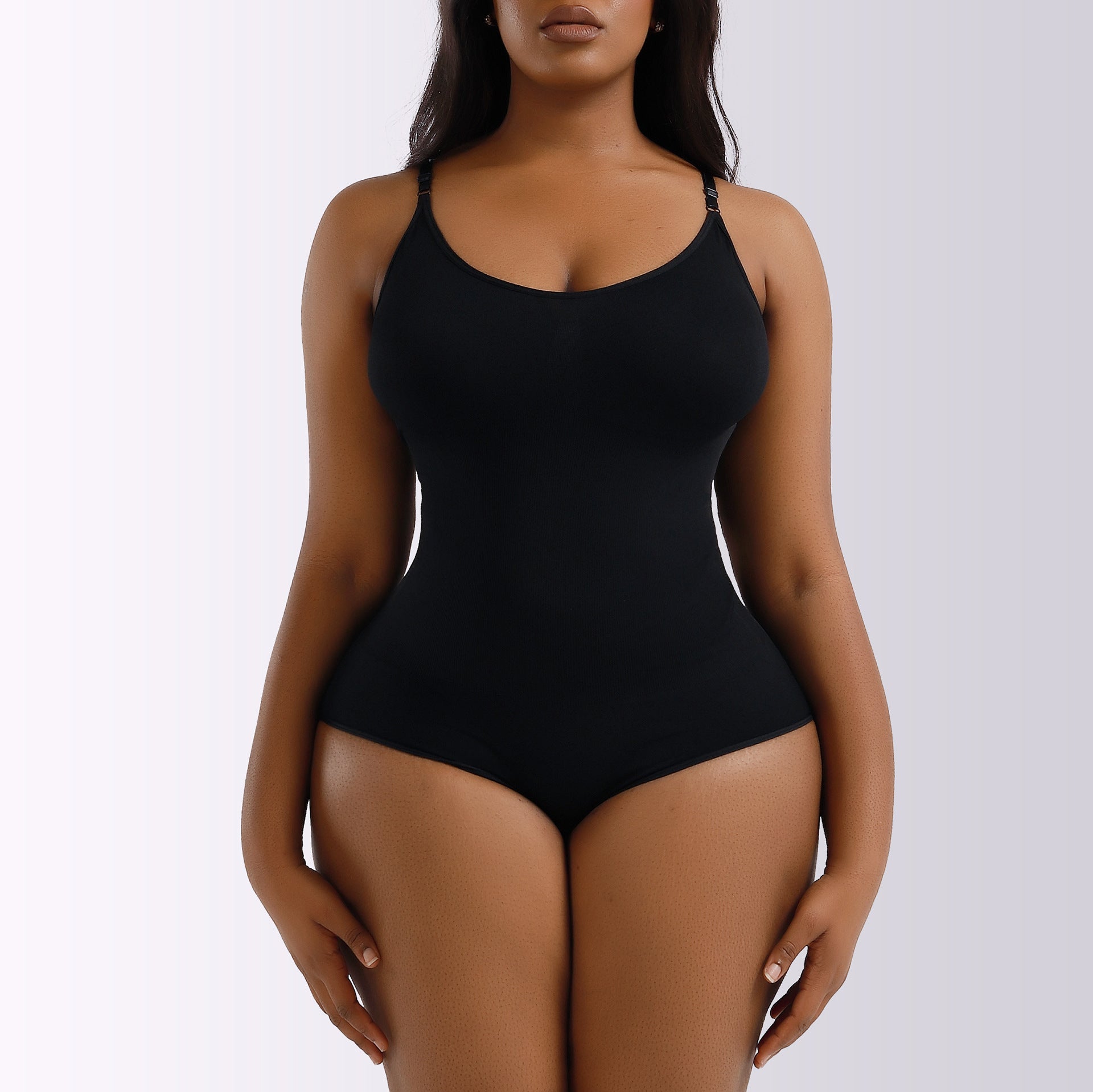 Black bodysuit worn by a model on a white background