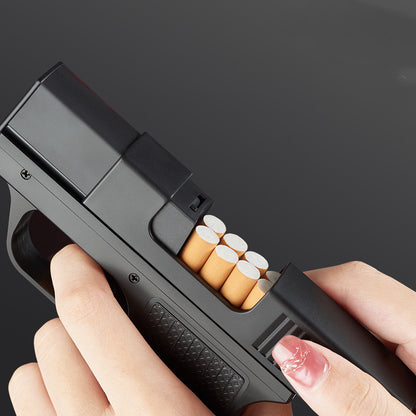 Hand holding a gun-shaped cigarette case with cigarettes inside on a black background