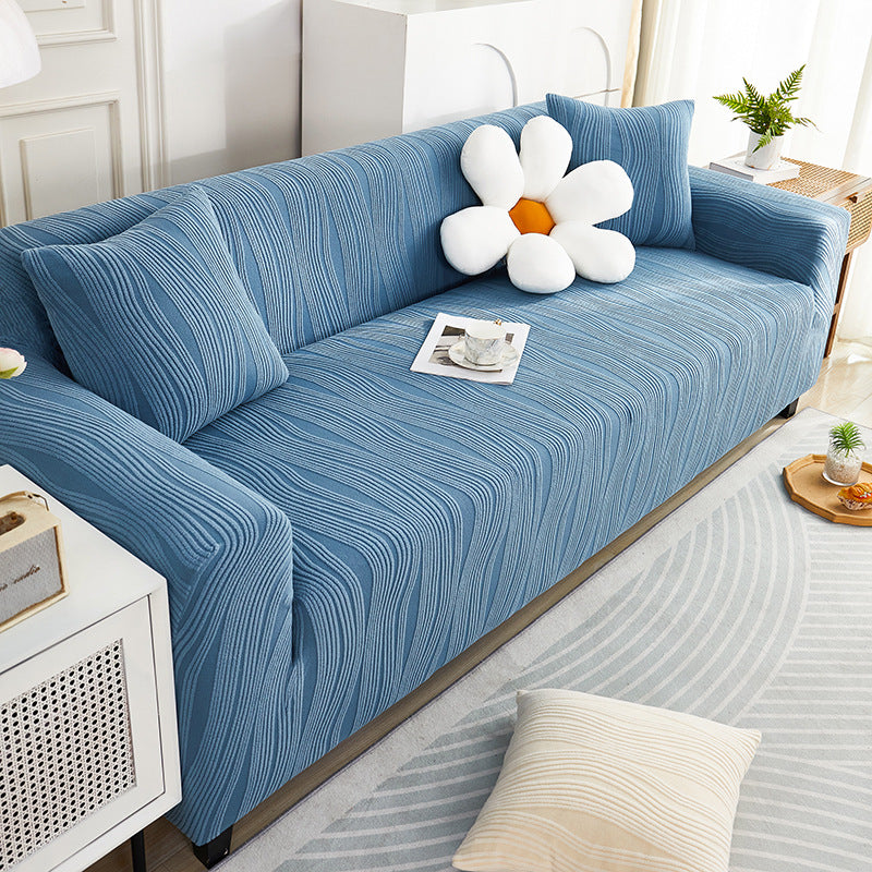 Blue sofa with a decorative flower pillow in a living room setting