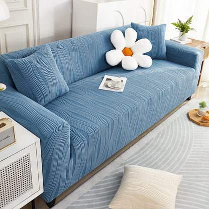 Blue sofa with a decorative flower pillow in a living room setting