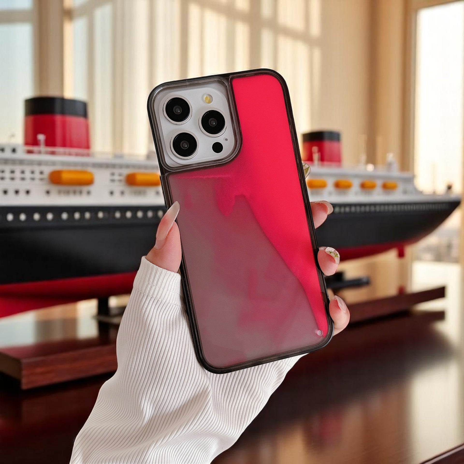 A selection of phone cases with a glowing quicksand design in various colors including red, blue, purple, and green, displayed on a white surface.