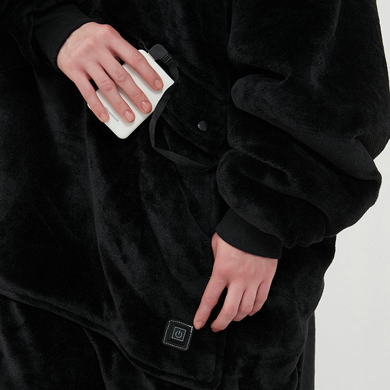 Person wearing a black robe with heated patches on a plain background