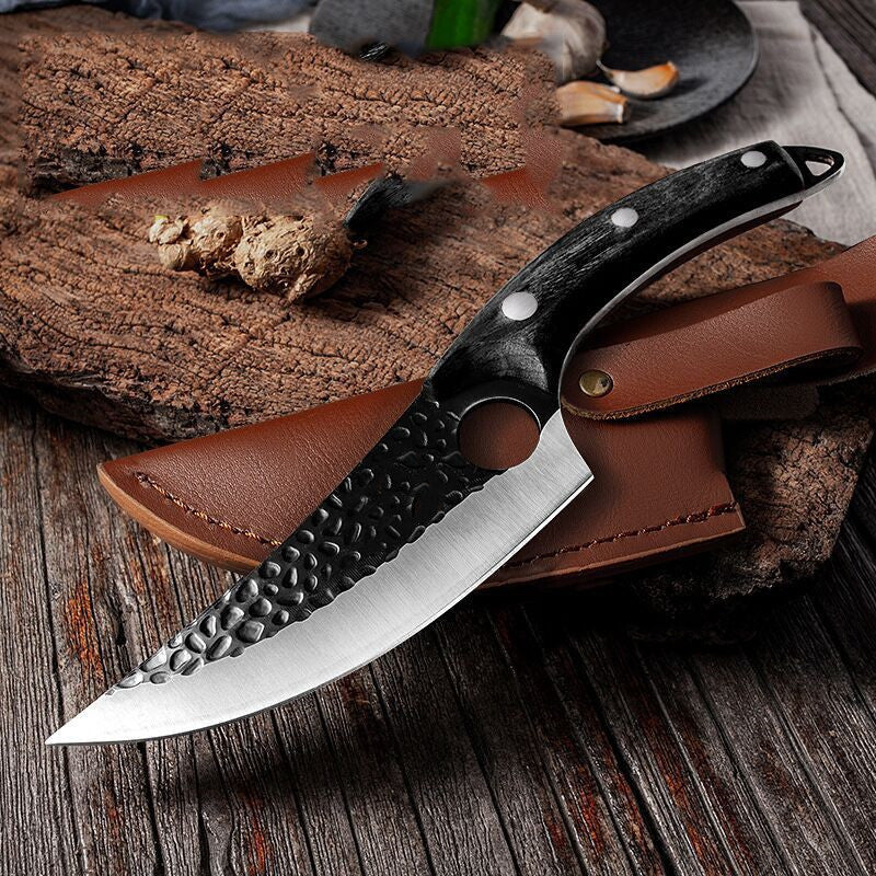 Knife with leather sheath on a wooden surface
