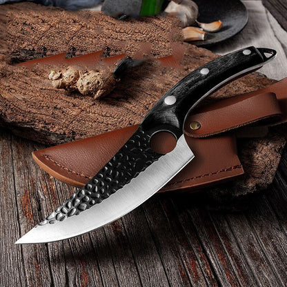 Knife with leather sheath on a wooden surface