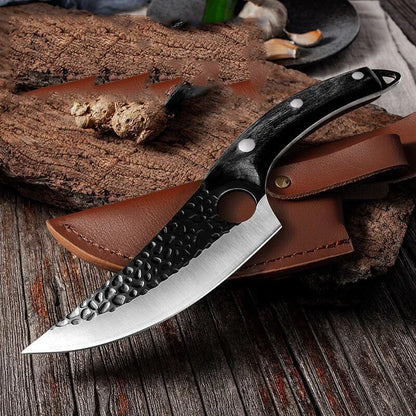 Knife with leather sheath on a wooden surface
