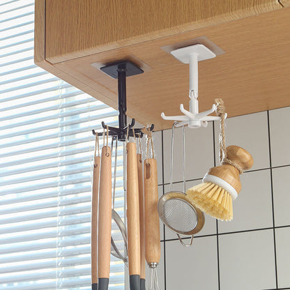 Ceiling hook with kitchen utensils hanging underneath a wooden cabinet.