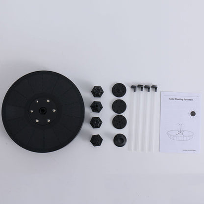 Black circular component, hexagonal parts, and a manual on a white background