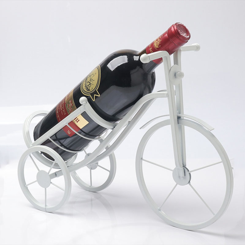 Wine bottle in a bicycle-shaped holder on a white background