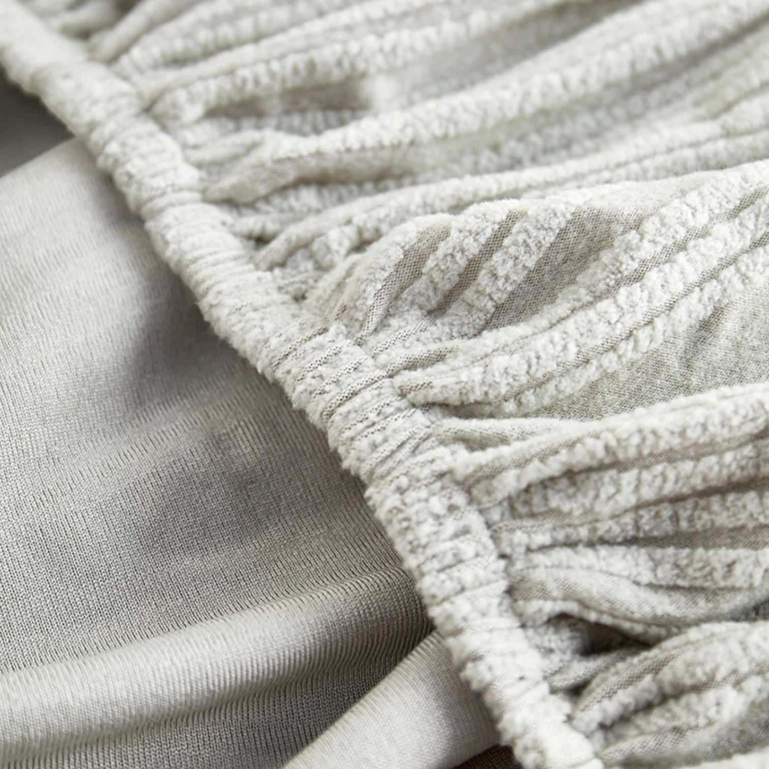 Close-up of textured beige fabric with a focus on texture and pattern.