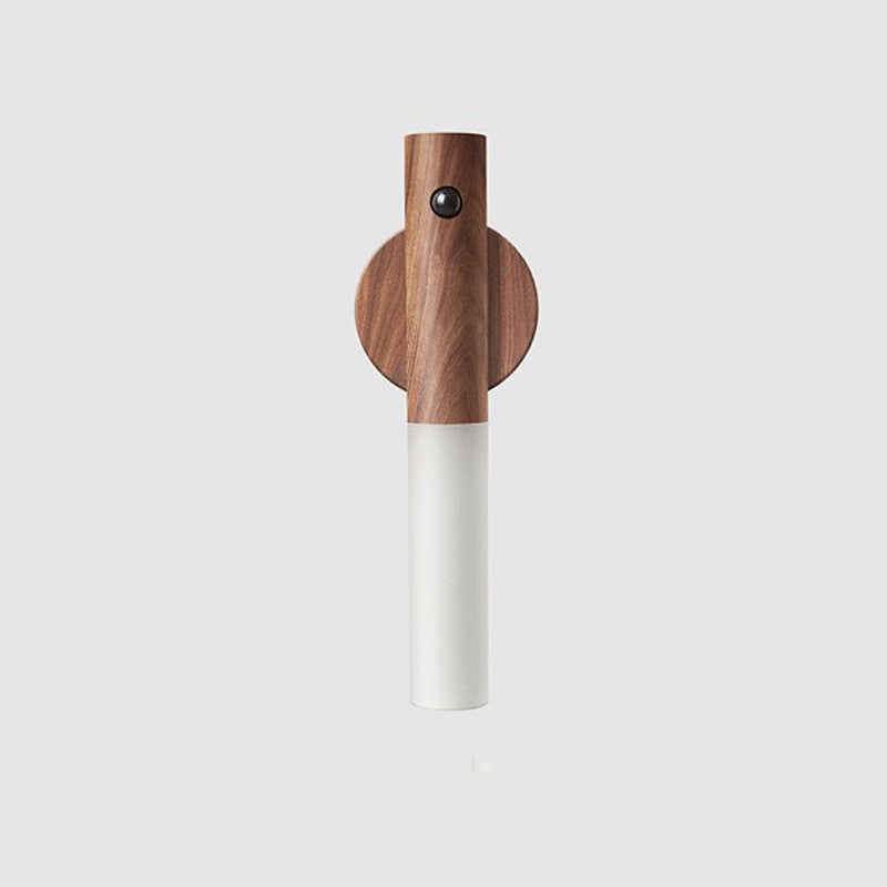 Wooden and white cylindrical object on a light gray background