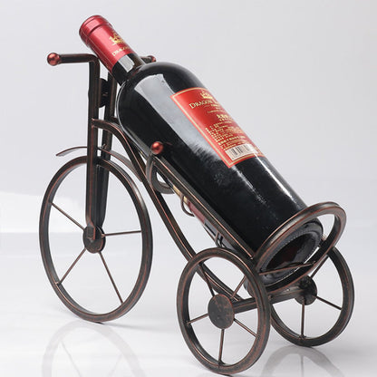 Wine bottle in a bicycle-shaped holder on a white background