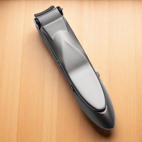 Black and silver hair clipper on a wooden surface
