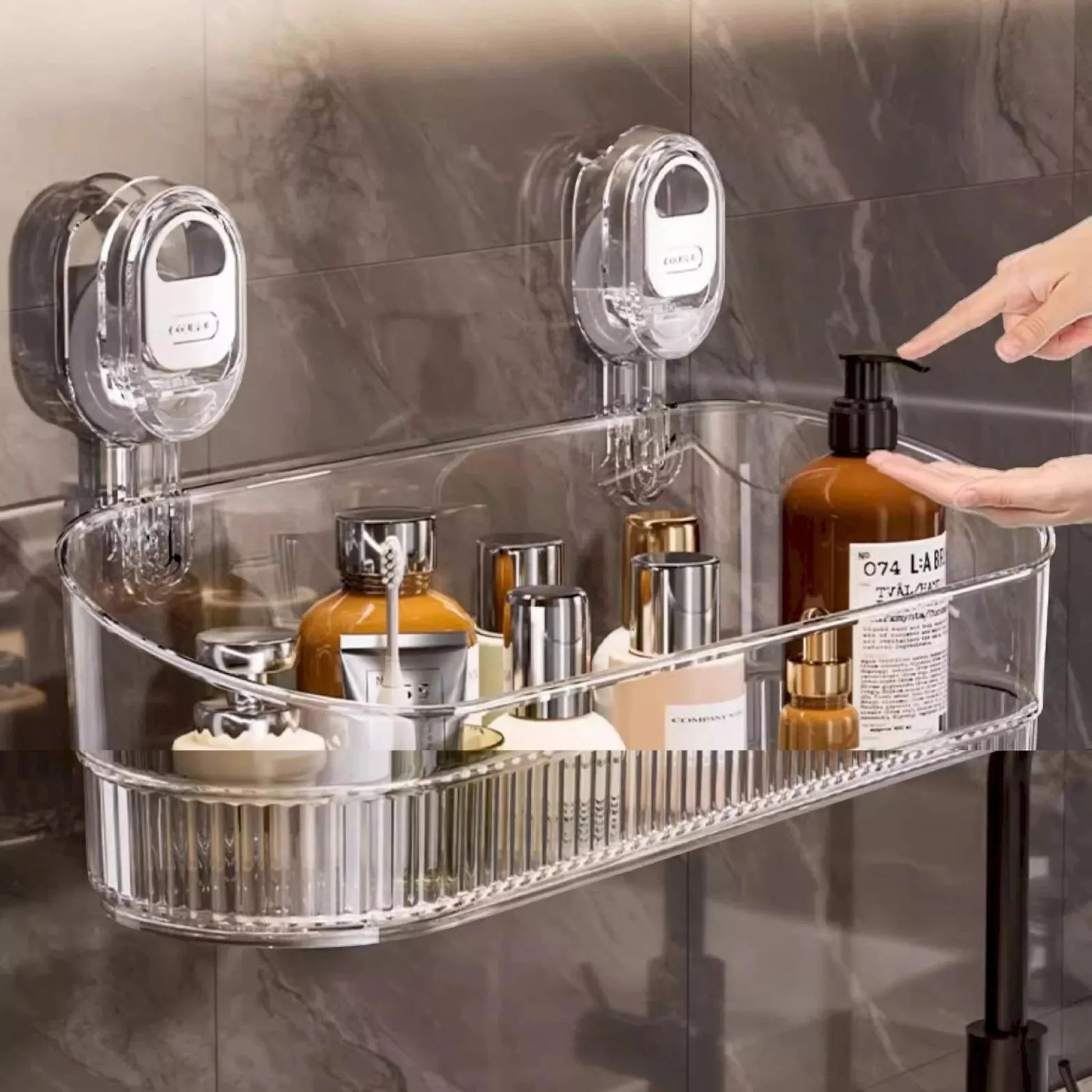 Clear shower caddy with various bottles on a marble wall background