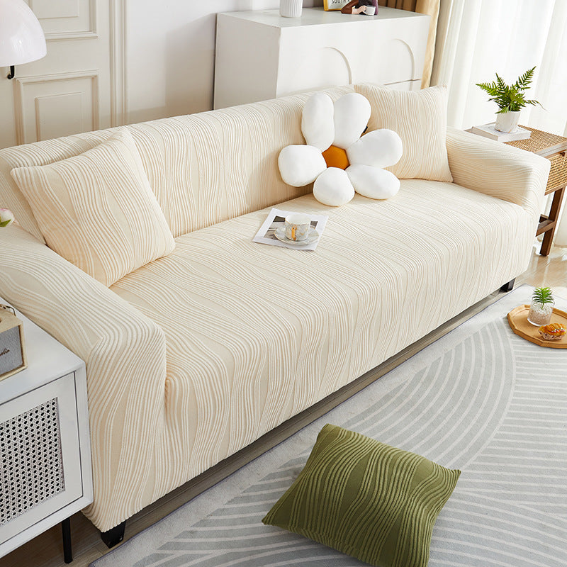 Beige sofa with decorative pillows in a living room setting