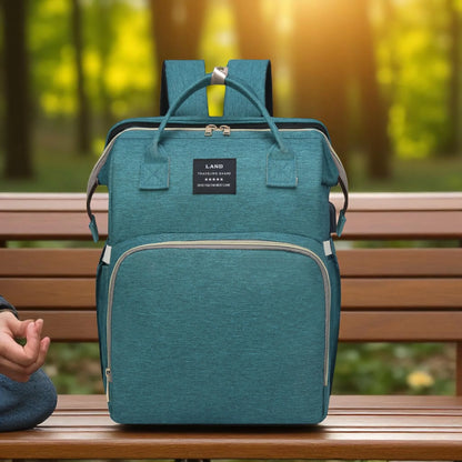 Teal backpack on a wooden bench with a blurred natural background