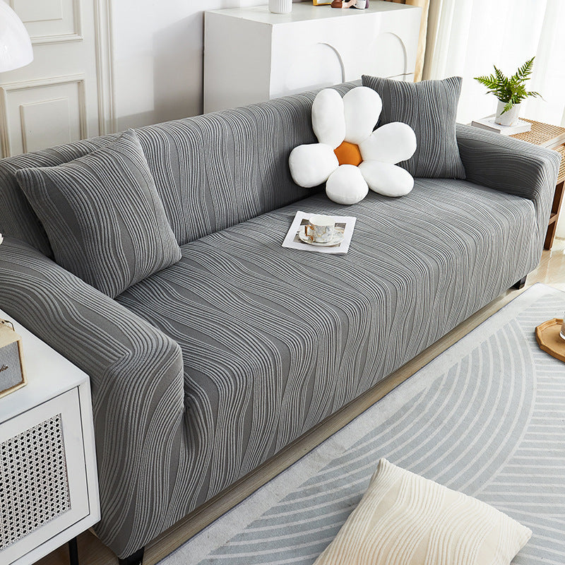 Gray striped sofa with decorative pillows in a living room setting
