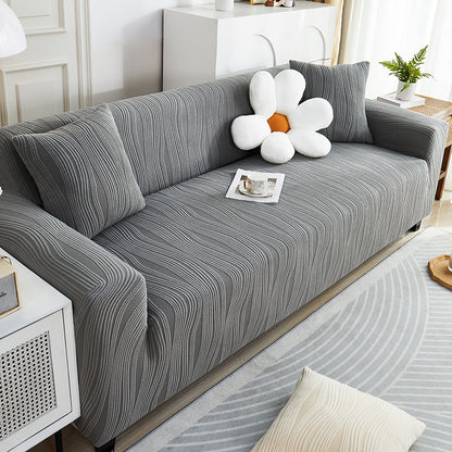 Gray striped sofa with decorative pillows in a living room setting