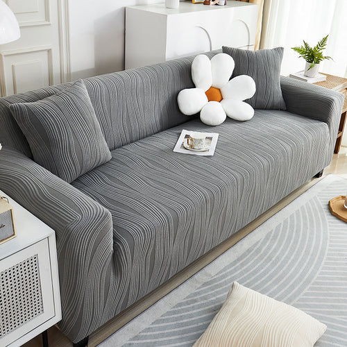 Gray striped sofa with decorative pillows in a living room setting