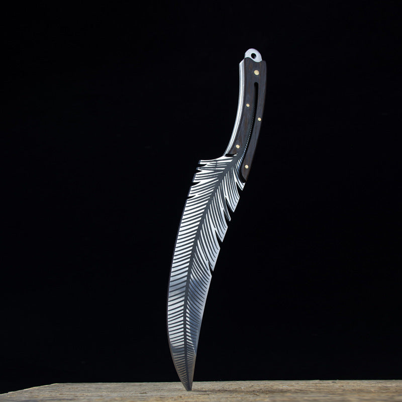 Forked knife with feather design on a black background