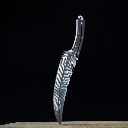 Forked knife with feather design on a black background
