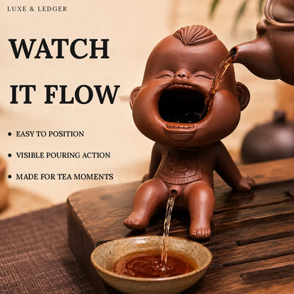 A terracotta-colored ceramic monkey-shaped tea infuser and pour-over vessel shown on a wooden table, with tea being poured into a small bowl and into a teapot at the top right. Large text on the left reads 'WATCH IT FLOW' with bullet points including 'EASY TO POSITION', 'VISIBLE POURING ACTION', and 'MADE FOR TEA MOMENTS'.
