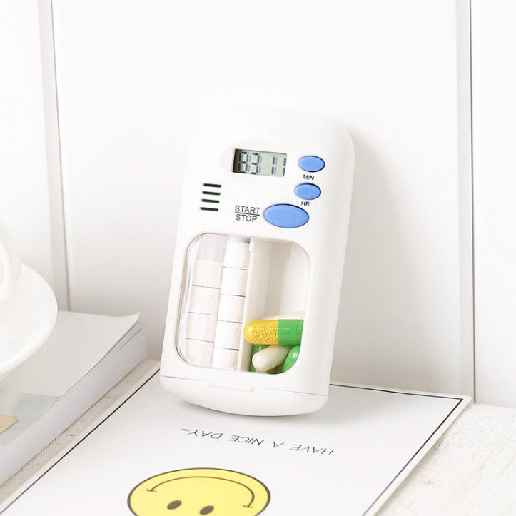 Digital timer with a white base and blue buttons on a light surface.
