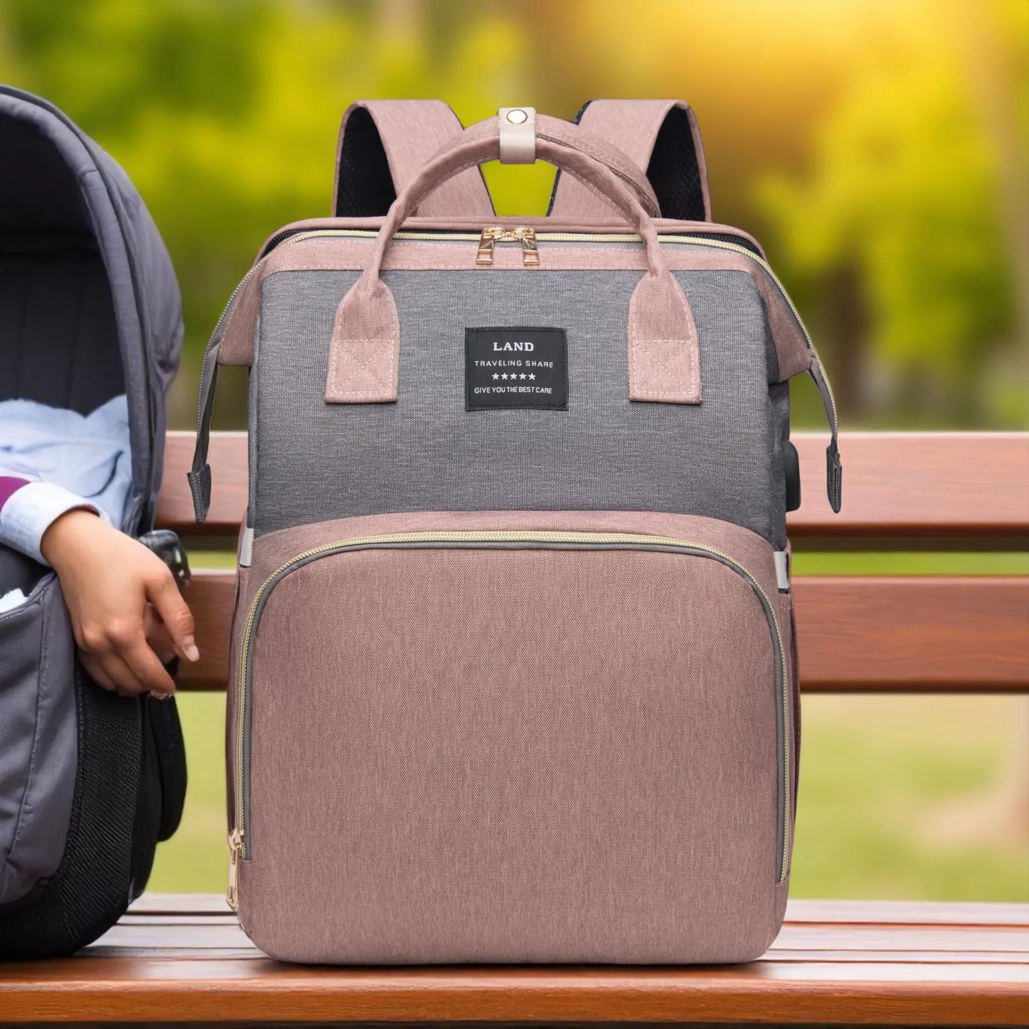 Gray and brown backpack on a wooden bench with a blurred natural background