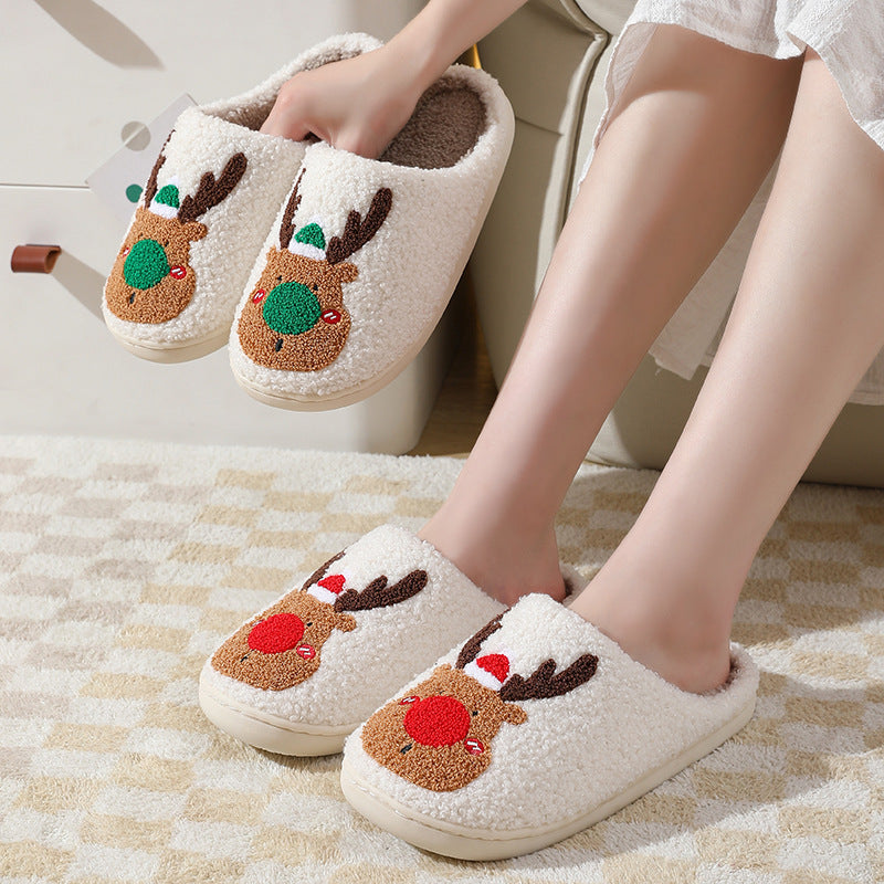 Reindeer-themed slippers worn indoors on a checkered floor.
