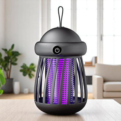 Black insect killer with purple light on a table in a room with plants and furniture.