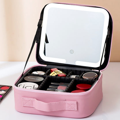 Pink makeup case with mirror containing various makeup items on a light background