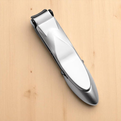 Silver nail clipper on a wooden surface